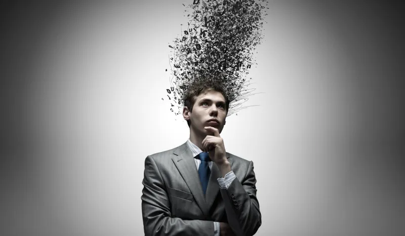 young thoughtful businessman and thoughts above his head