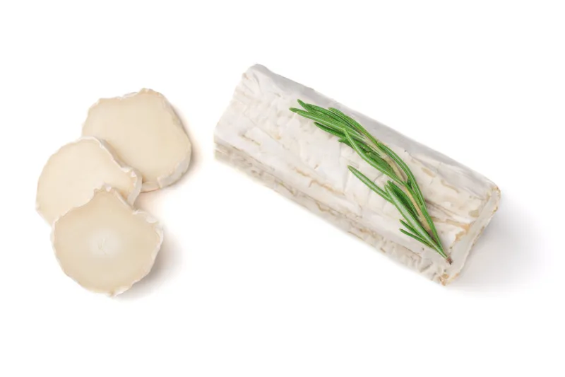 slices goat cheese and goat cheese piece with rosemary isolated on white background culinary cheese eating