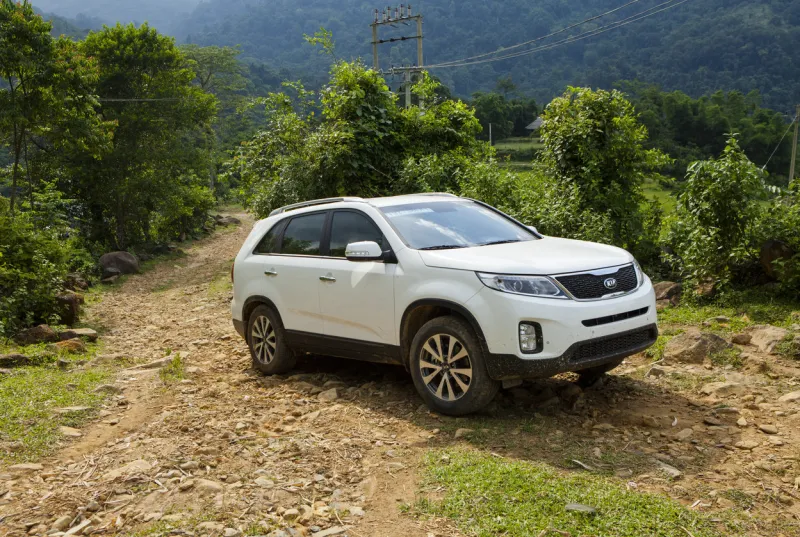 hoabinh, vietnam - jun 3, 2014  kia new sorento car is running on the mountain road in test drive, vietnam
