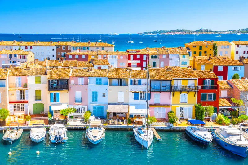 view of colorful houses and boats in port grimaud during summer day-port grimaud, france