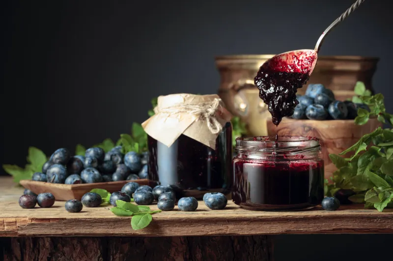 blueberry jam with fresh berries on an old wooden table copy space