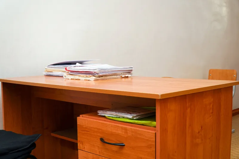 a stack of papers on a desktop without a computer