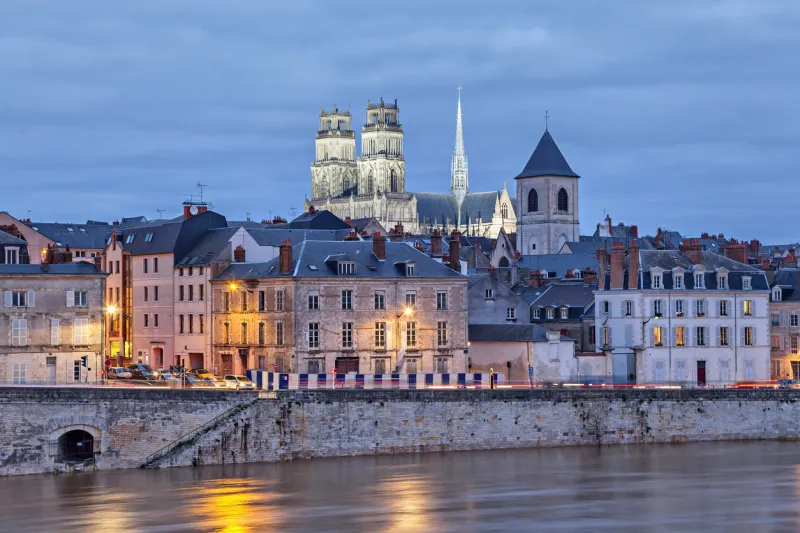 embankment of loire river and orleans cathedral in the evening, orleans, france