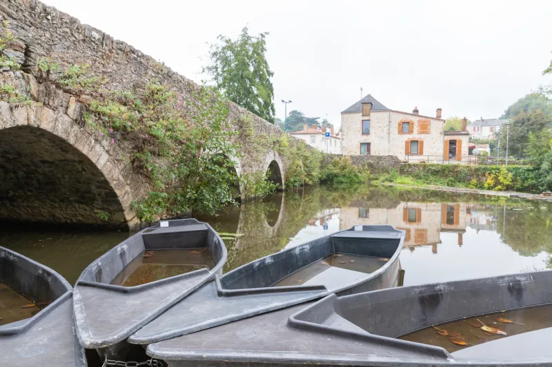 rocheserviere, pays de la loire, france - september 21, 2020  small rental boat docked on the la boulogne river near the restaurant le moulin on an autumn day