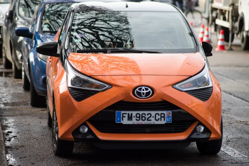 strasbourg - france - 4 february 2021 - front view of orange toyota yaris parked in the street