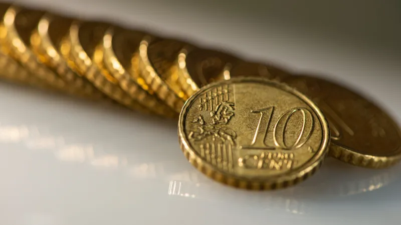 coin ten euro cents and a stack of coins lies on the surface of the table web banner business concept