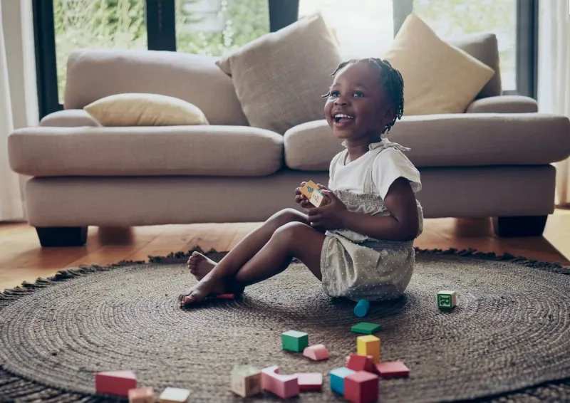 shot of a little girl playing with blocks at home