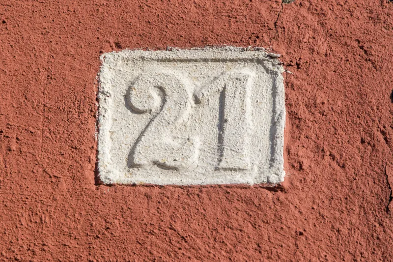 old retro weathered cast iron plate with number