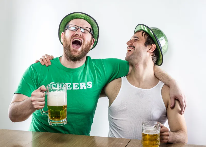 two laughing irish men celebrating, singing on st patrick's day