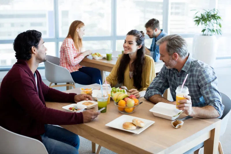 creative business team discussing while having meal in office