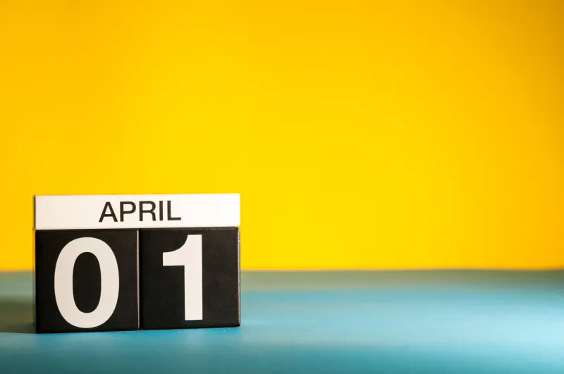 april 1st day 1 of april month, calendar on table with yellow background spring time, empty space for text