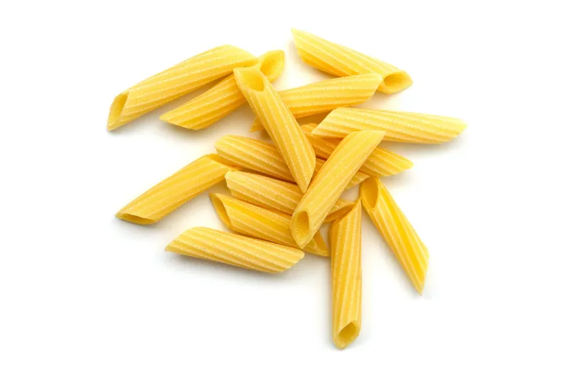 penne pasta uncooked white background