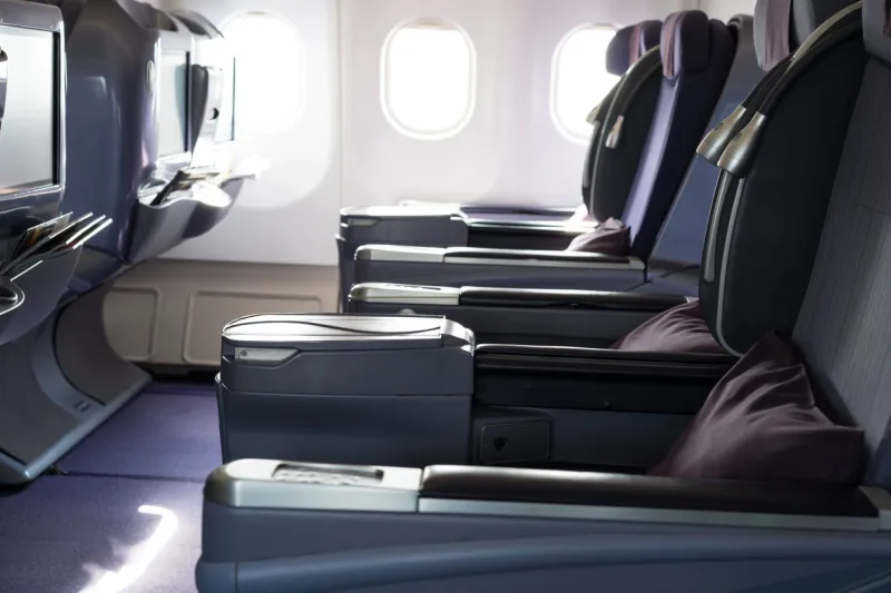 airplane seat beside window in plane