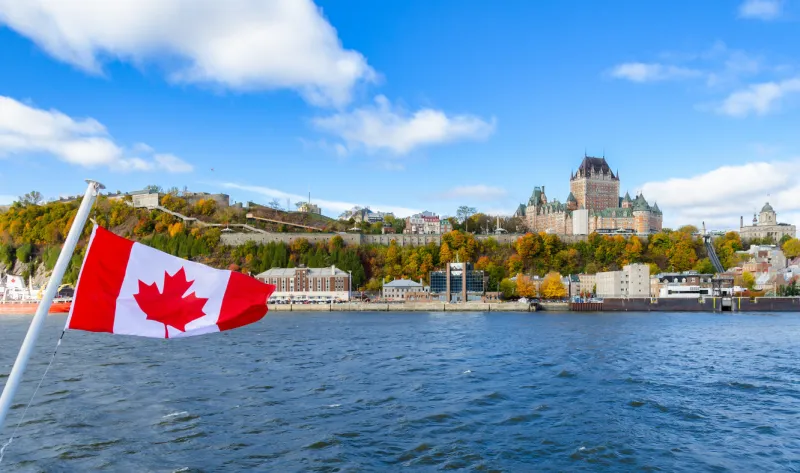 panoramic autumn view of old quebec city waterfront and upper town from saint-lawrence river in quebec, canada