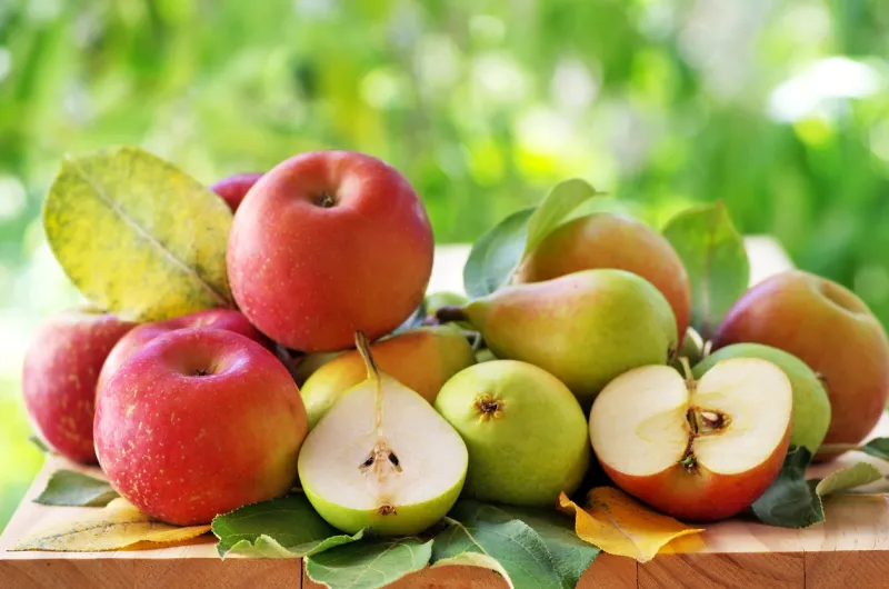 pears and apples on a rustic wooden table