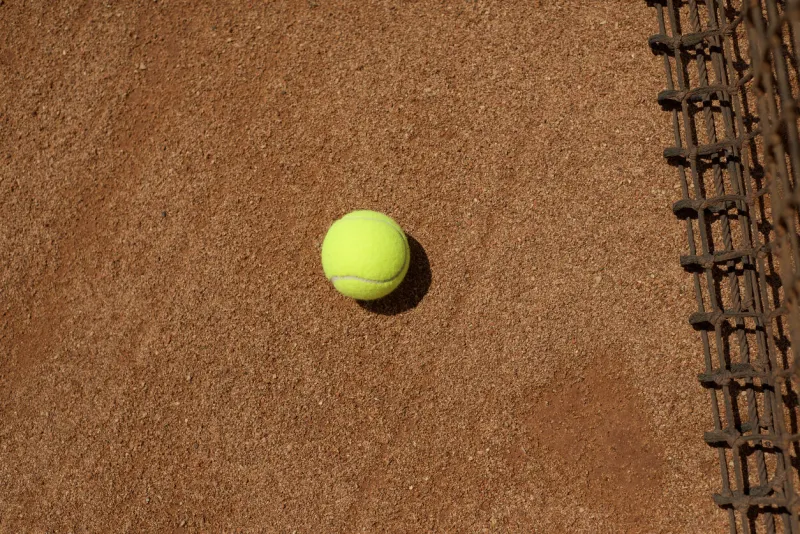 tennis yellow ball on a clay court tennis net sports backgrounds copy space for text