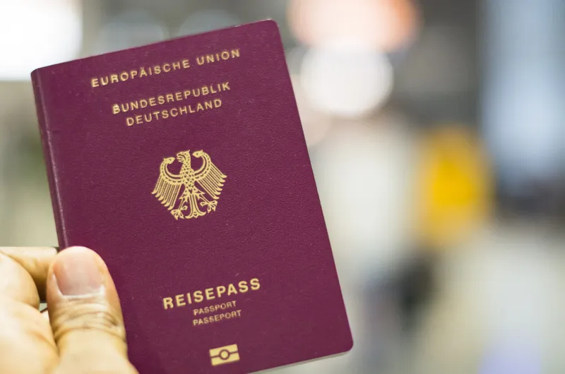 munich, germany - september 29 2019  passenger holding german passport at the airport in munich, germany