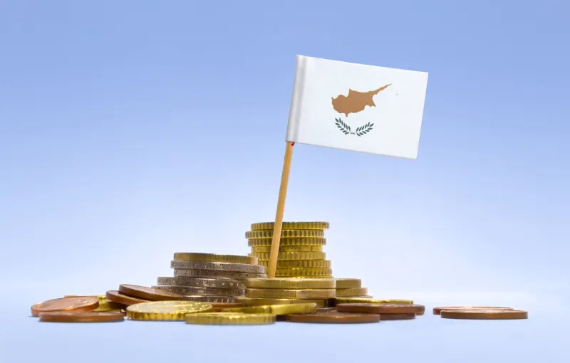 flag of cyprus in a mixed stack of european coins and a blue background(series)