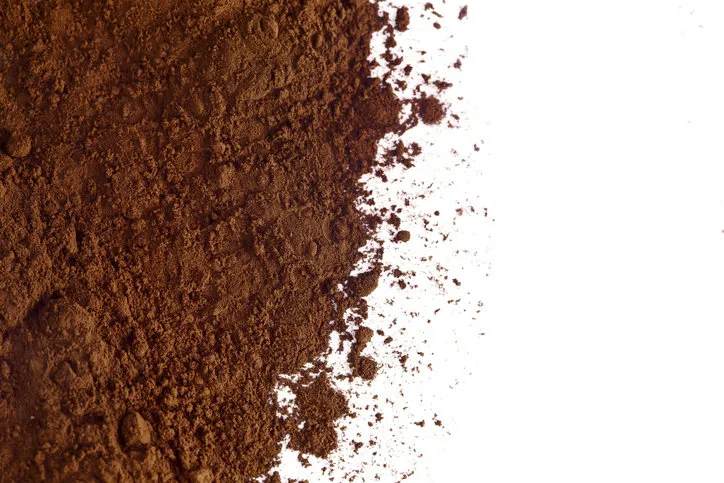 heap of cacao powder on a white background top view