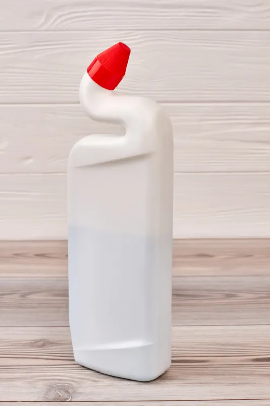 plastic bottle with cleaning product toilet duck liquid cleaner for home hygiene, wooden background house cleaning supply