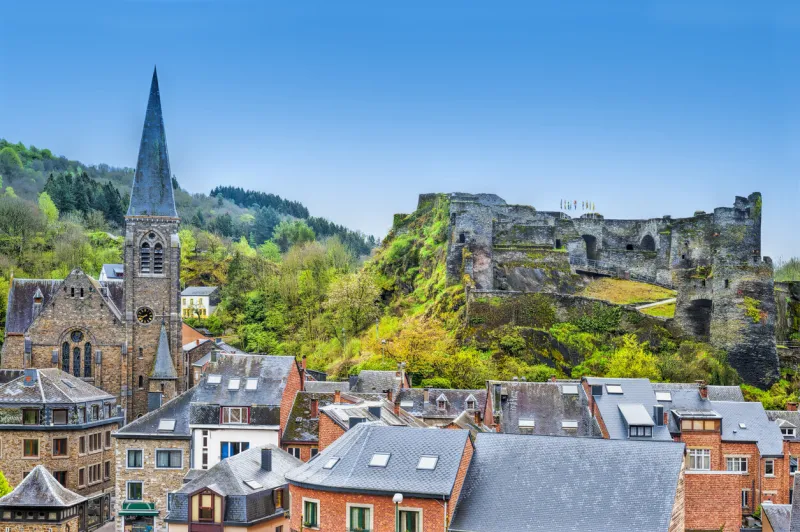 view of the church and the castle in the belgian city of la roche view of the town centre below its medieval castle in of la roche
