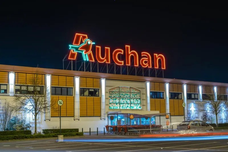 roncq,france-february 27,2019  night view of auchan supermarket logo, entrance and parkingauchan is a french international supermarket chain, is one of the largest distribution groups in the world
