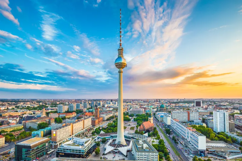 berlin skyline panorama with famous tv tower at alexanderplatz and dramatic cloudscape at sunset, germany