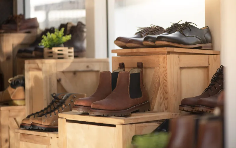 men fashion shoe boots on the wooden box in the store retail shopping