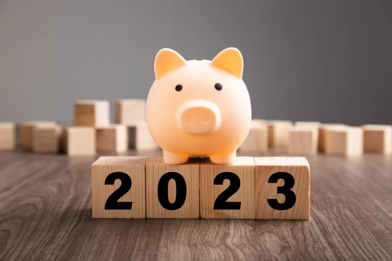 budget plan 2023 piggy bank on top of wooden block
