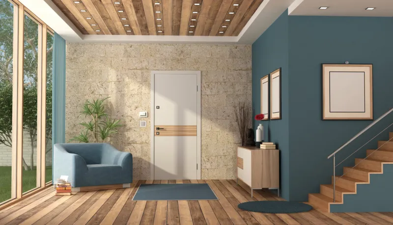 home entrance of a contemporary villa with front door ,modern furniture and wooden staircase - 3d renderingthe room does not exist in reality, property model is not necessary