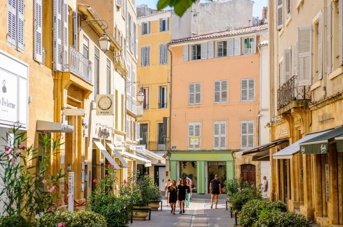 aix, france - july 17, 2014  beautiful shopping area in aix-en-provence with tourists walking betweens luxury shops on a warm summer day on rue nazareth