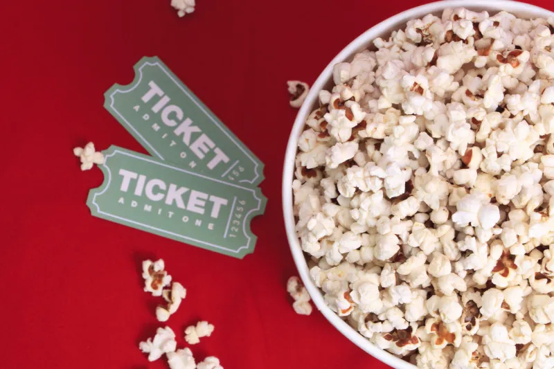 top view of popcorn and movie tickets