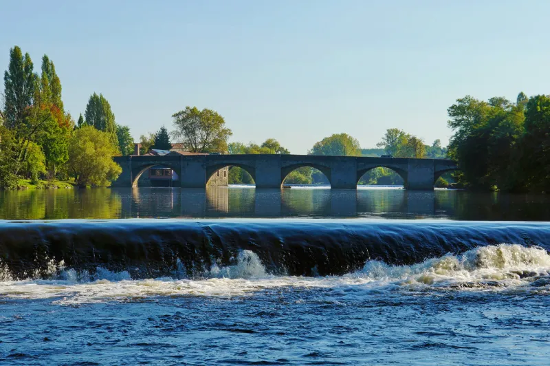old stone bridge notre-dame across the vienne river, saint-junien, limousin, france