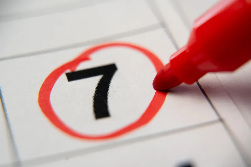 the calendar 7st day of the month is circled a red marker circles the first day of the paper calendar a very important date in the calendar