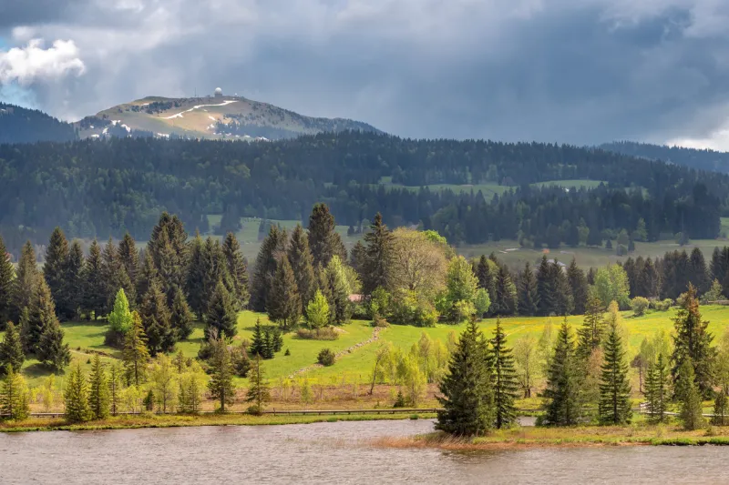 view over the lake of les rousses in the jura mountains (france) with the mount la dole (switzerland) in the background