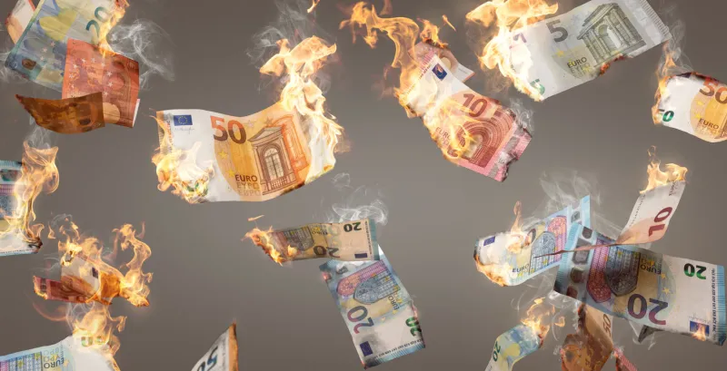 multiple euro banknotes on fire falling down isolated on a neutral background