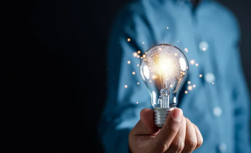 innovation through ideas and inspiration ideas human hand holding light bulb to illuminate, idea of creativity and inspiration concept of sustainable business development