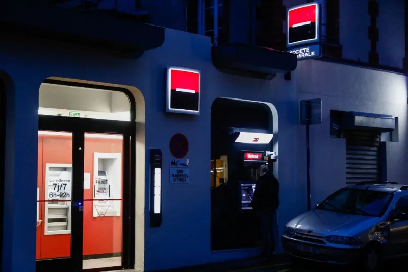 a man uses the cash machine of a societe generale bank, in ouistreham, normandy, northwestern france, on october 28, 2019 (photo by sameer al-doumy   afp)