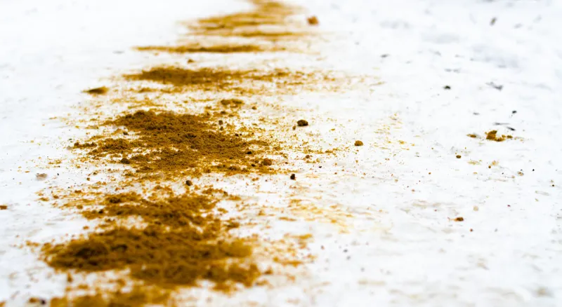 the winter sidewalk is sprinkled with sand ice, injury sand in the snow sand in the macro on the snow safety