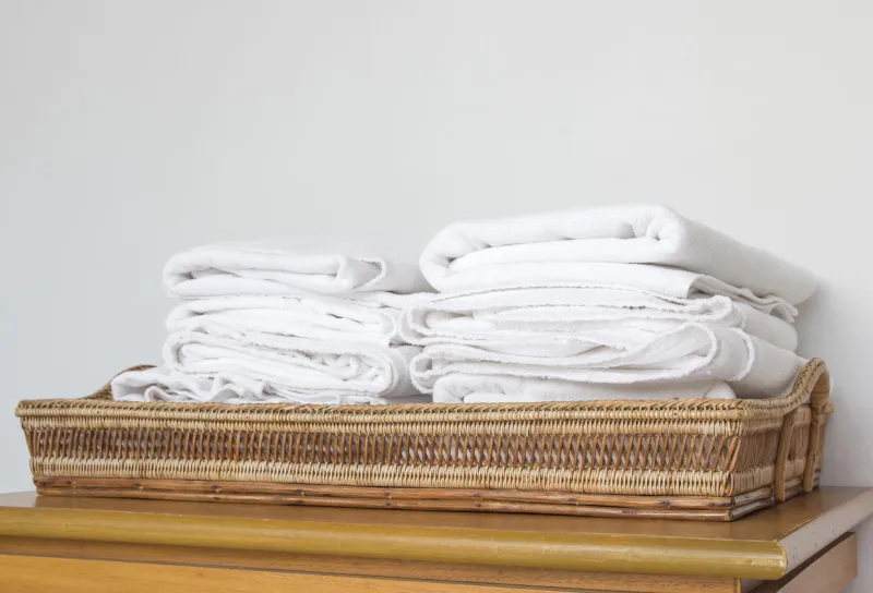 stack of white towels on basket