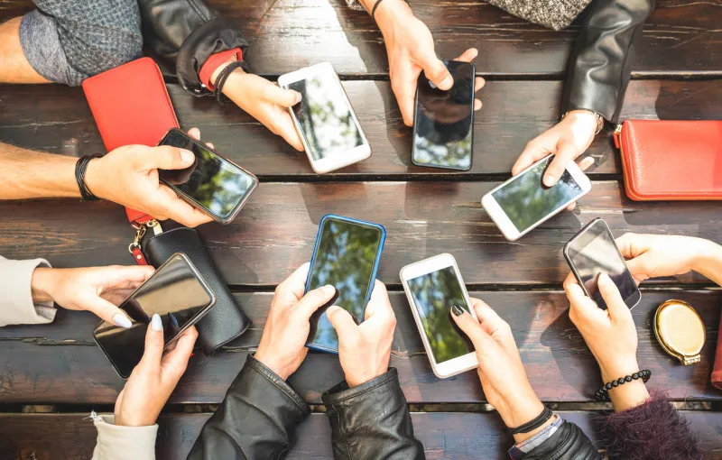people group having addicted fun together using smartphones - detail of hands sharing content on social network with mobile smart phones - technology concept with millennials online with cellphones