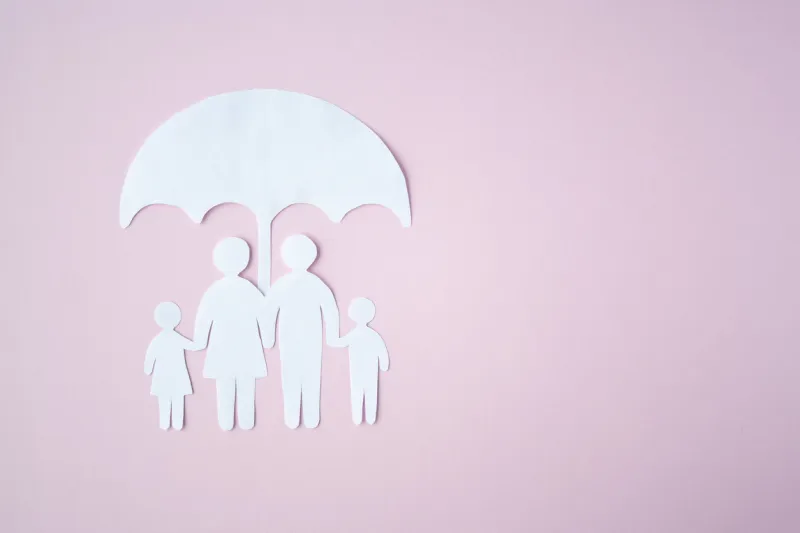 concept of social protection family paper cut family under umbrella on bright pink background life insurance, family protection