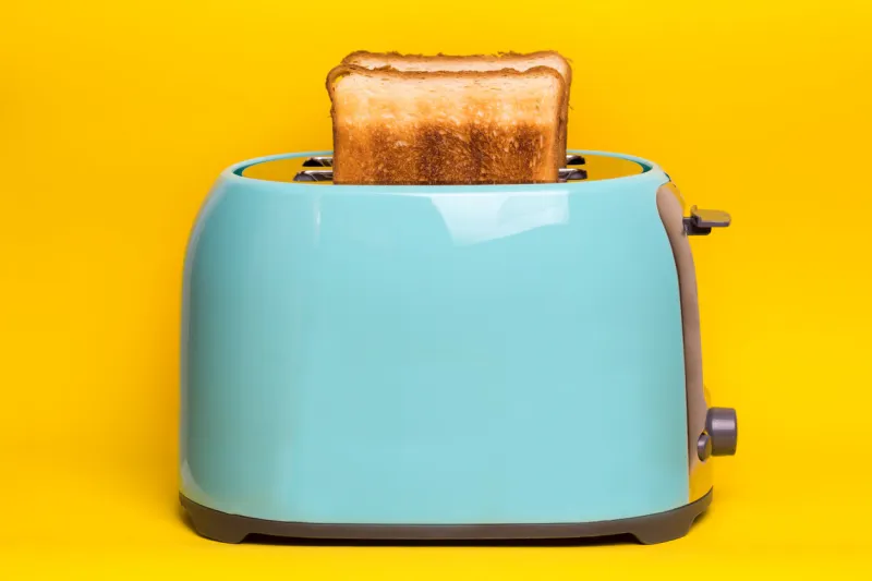 bright, fun breakfast cyan color toaster on a wooden background n