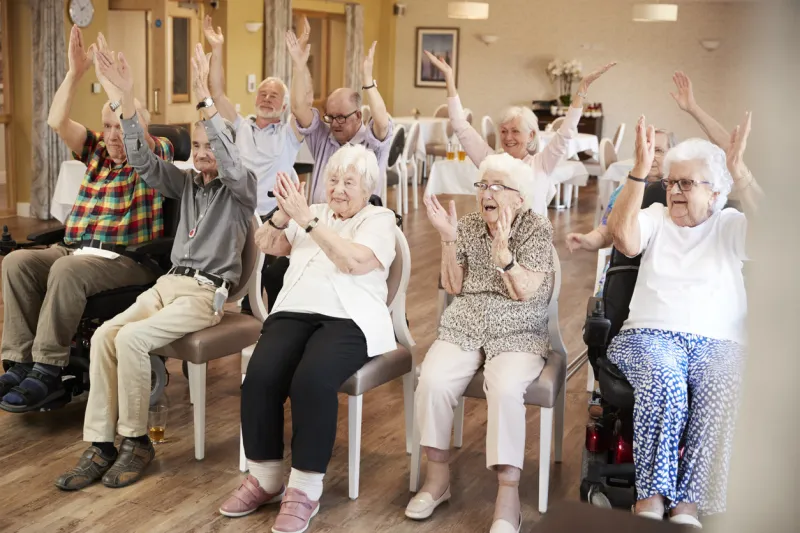group of seniors enjoying fitness class in retirement home