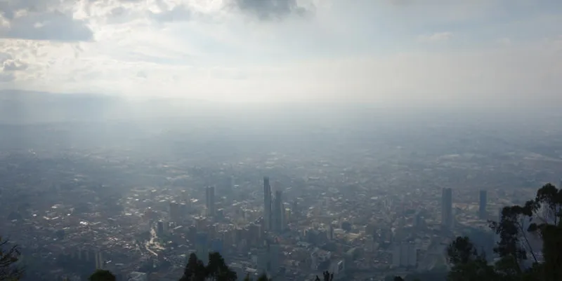 bogota city as seen from city peak monserrate with clouds, dust and sun beams breaking through