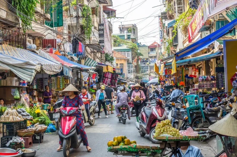 hanoi,vietnam - october 31,2017   busy local daily life of the morning street market in hanoi, vietnam a busy crowd of sellers and buyers in the market