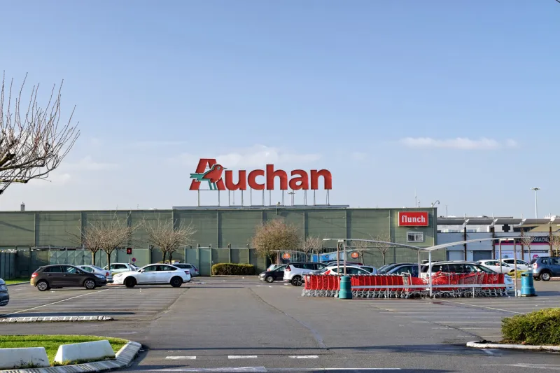 leers,france-january 19,2020  view of auchan supermarket logo and parkingauchan is a french international supermarket chain, is one of the largest distribution groups in the world