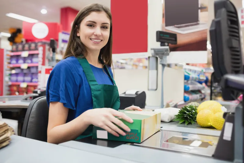 portrait of woman cashier smiling at checkout