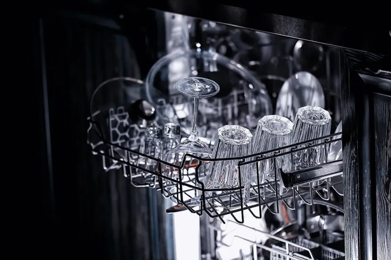 dishes in an open dishwasher, home style lifestyle, cleanliness and convenience background