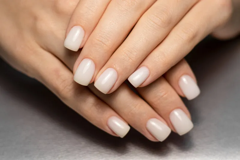 beautiful nude manicure short square nails nail design manicure with gel polish close-up of the hands of a young woman with a delicate nude manicure on her nails elegant nails with gel polish